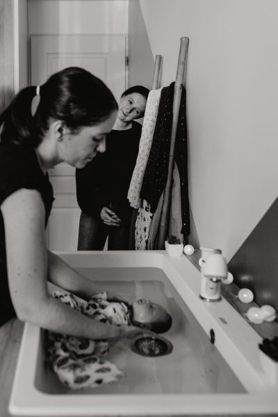 sourire d'une maman attendrie pendant le bain bébé photographié par stephanie daillet